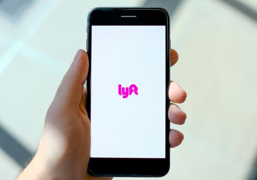 A phone displays the Lyft app
