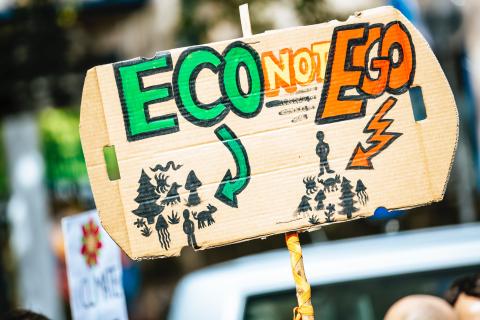 Sign with "eco, not ego" written on it